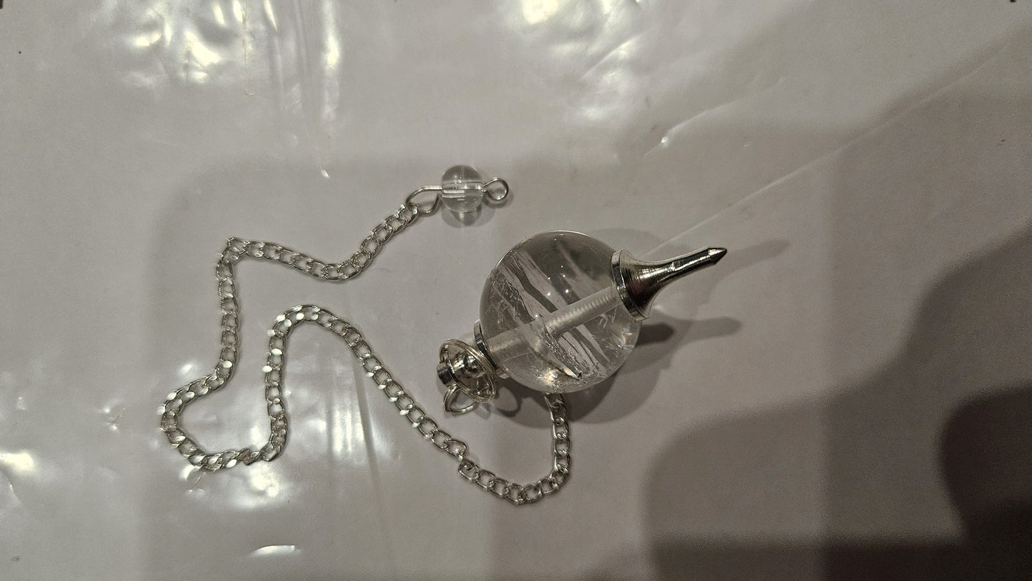 Clear quartz ball pendulum on silver chain angle view