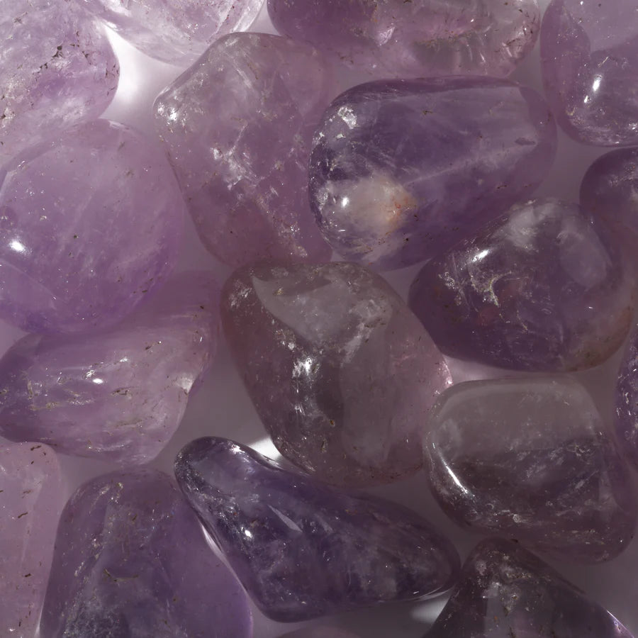 Natural purple amethyst palm stone with visible crystalline structure for energy work