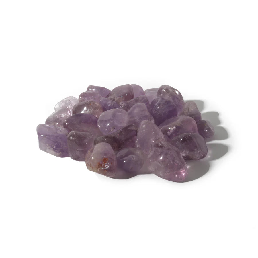 Collection of amethyst tumbled stones showing color variations for crystal healing practice