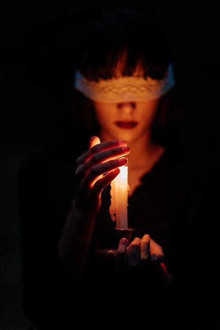 Woman holding candle in mystical setting - ritual and sacred symbolism