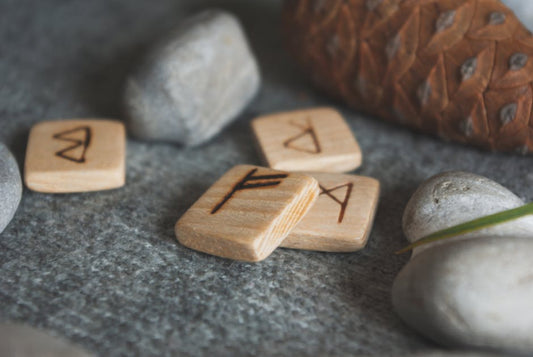 Wooden rune stones with Elder Futhark symbols carved