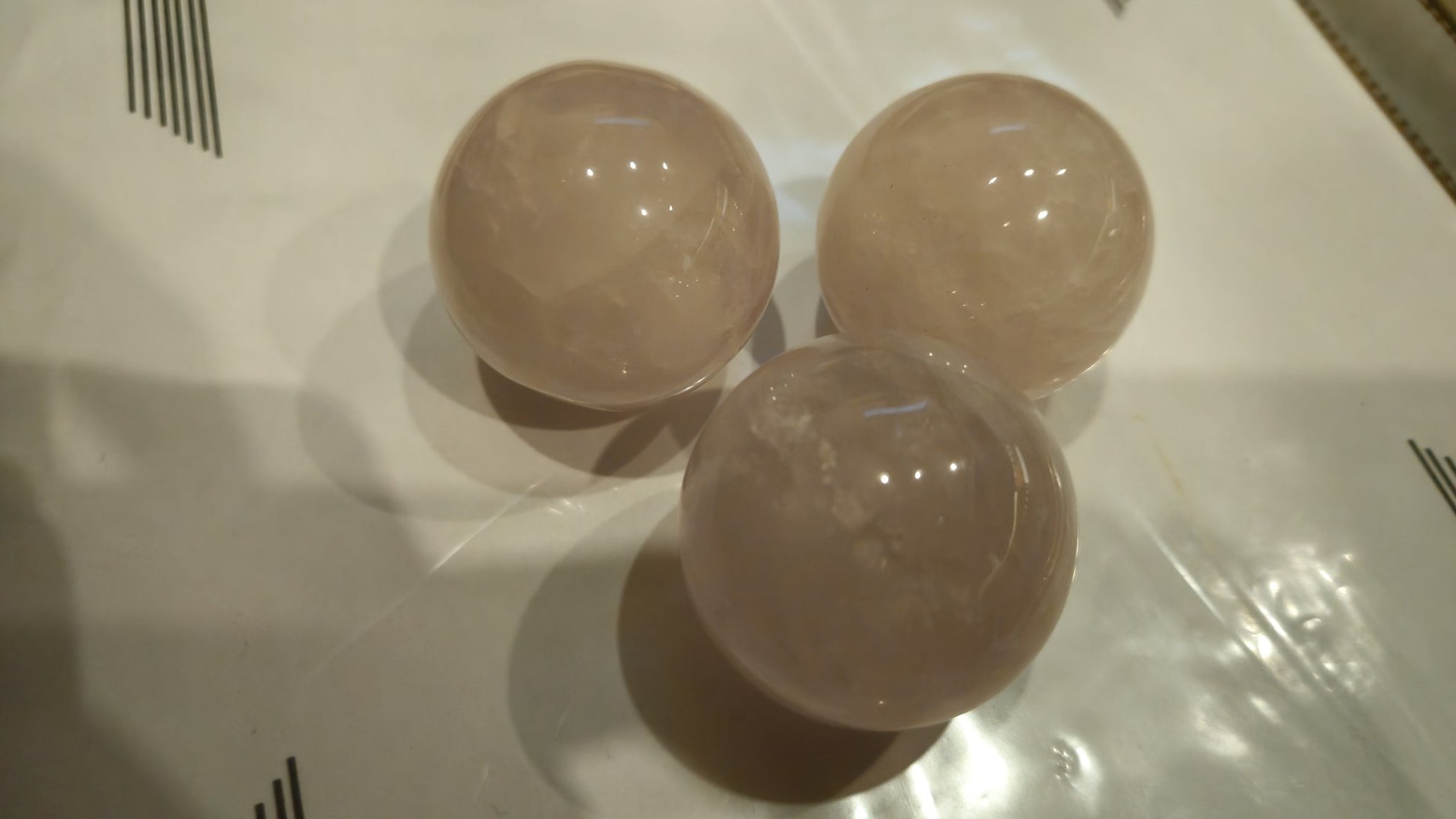 Three rose quartz spheres 40mm close-up showing pink clarity and polish