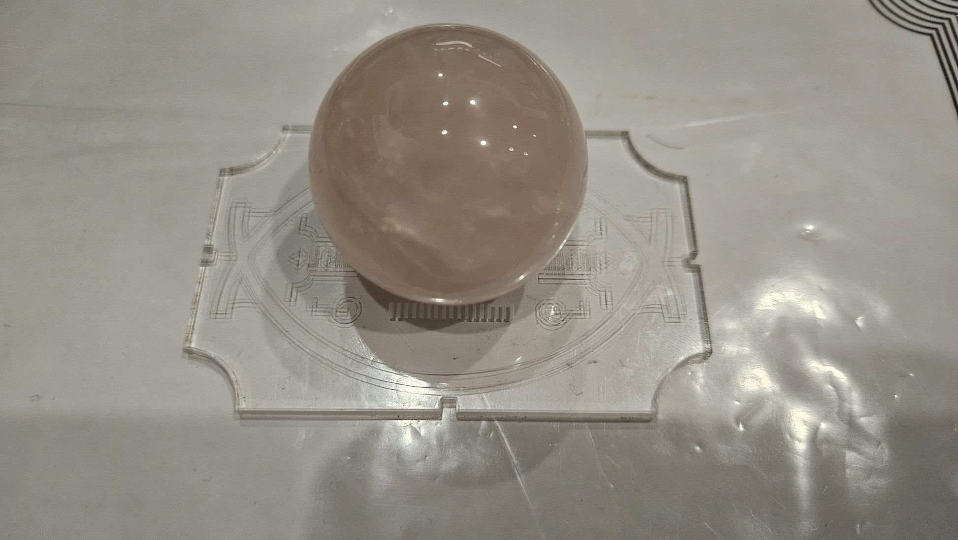 Single rose quartz sphere 40mm hero shot on sacred geometry acrylic stand