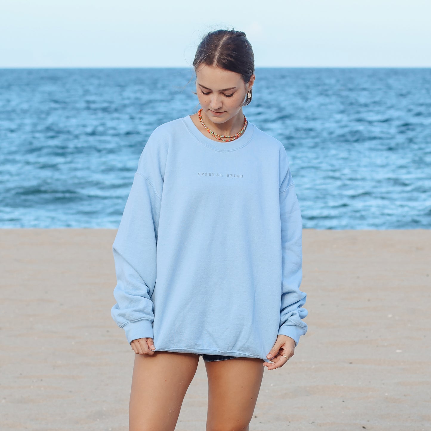 Woman Wearing Eternal Being Embroidered Blue Sweatshirt | Esoteric Apparel | Thalira